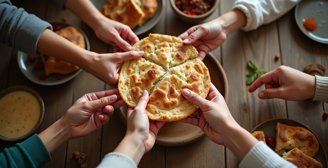 Mains multiples partageant le pain lavash lors d'un repas traditionnel arménien